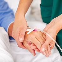 Nurse holding patients hand in hospital